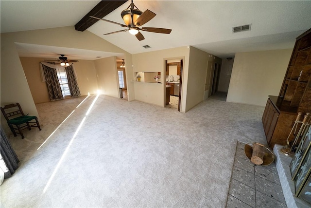 carpeted living room featuring ceiling fan and lofted ceiling with beams