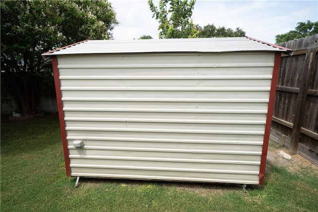 view of outbuilding with a yard