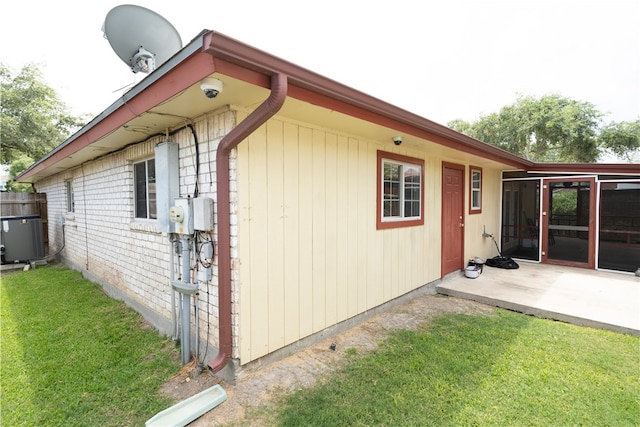 view of home's exterior featuring a yard, cooling unit, and a patio area