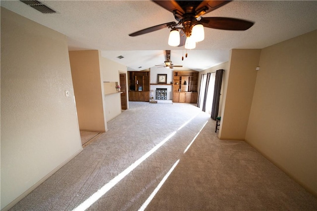 corridor with light carpet and vaulted ceiling