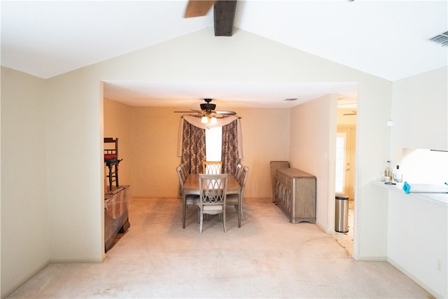 carpeted dining area with vaulted ceiling with beams and ceiling fan