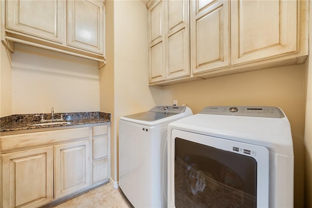 washroom with washer and clothes dryer, cabinet space, and a sink
