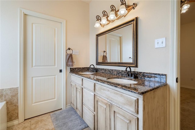 bathroom with double vanity, tile patterned flooring, and a sink