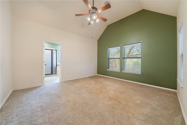carpeted empty room featuring a healthy amount of sunlight, baseboards, ceiling fan, and lofted ceiling