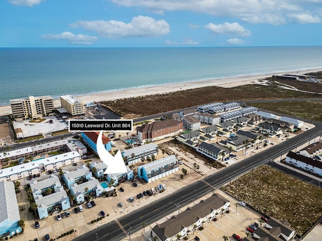 drone / aerial view with a water view and a beach view