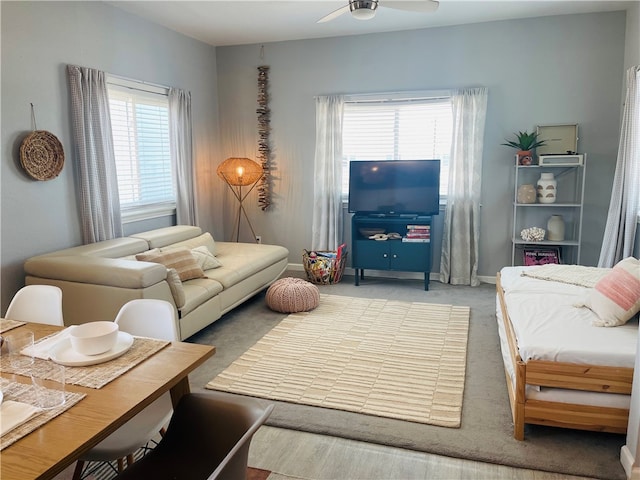 carpeted living room featuring ceiling fan