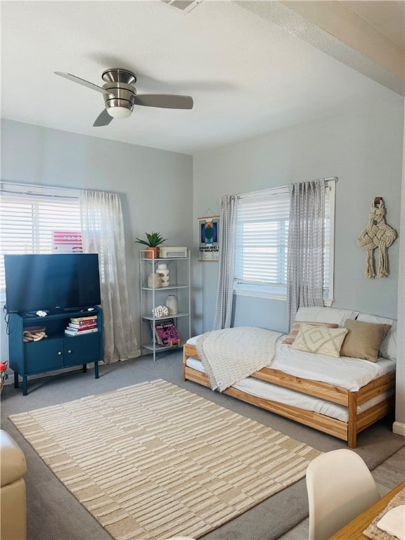 bedroom with multiple windows, carpet flooring, and ceiling fan