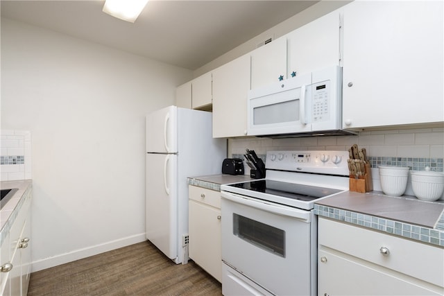 kitchen featuring dark wood-type flooring, tasteful backsplash, white cabinetry, and white appliances