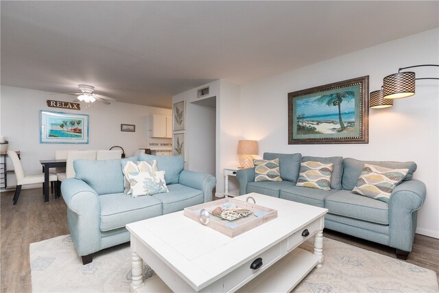 living room featuring ceiling fan and light hardwood / wood-style flooring