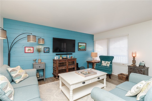 living room with wood walls and wood-type flooring