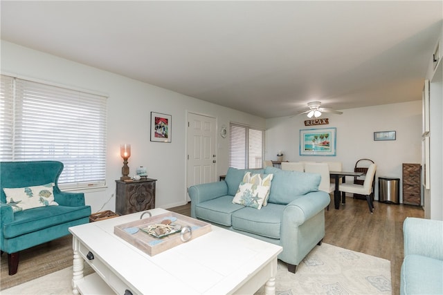 living room featuring ceiling fan and light wood-type flooring