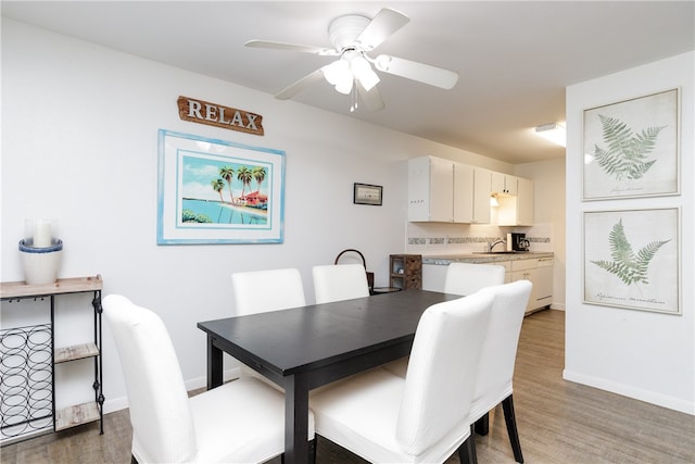 dining area with ceiling fan, wood-type flooring, and sink