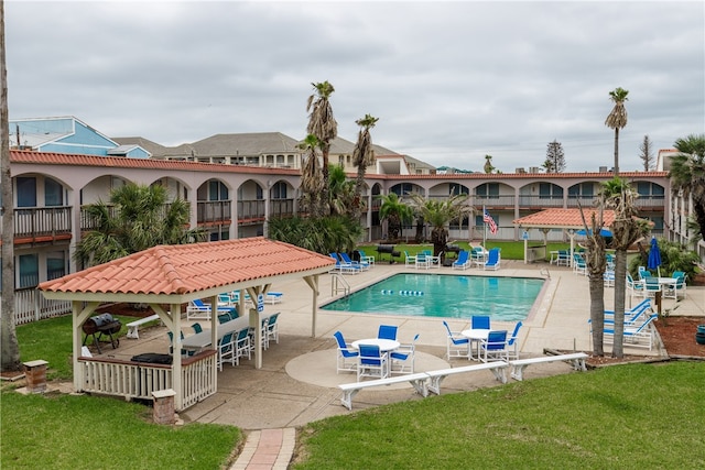 view of pool featuring a patio and a lawn