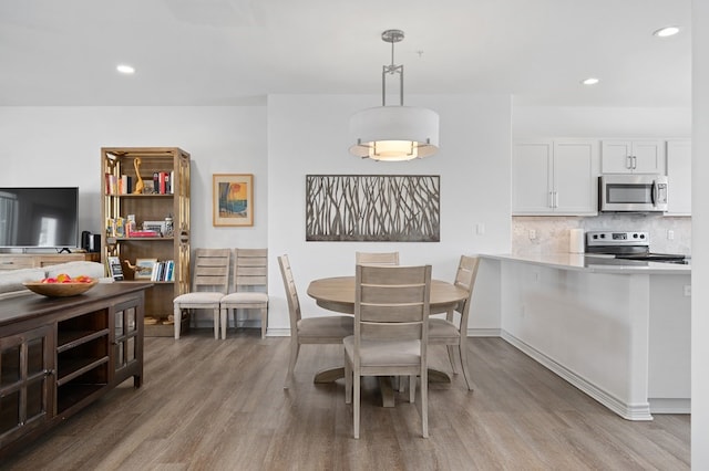 28 Sandollar Unit # F, Rockport, TX 78382 - dining space featuring wood finished floors, recessed lighting, and baseboards