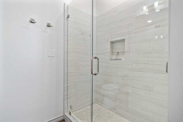 bathroom with a shower with shower door