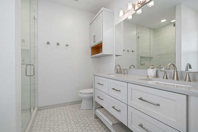 bathroom with tile patterned flooring, vanity, an enclosed shower, and toilet