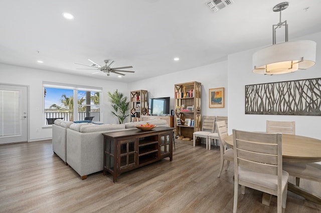 living room featuring light wood-type flooring and ceiling fan