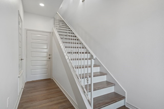 stairway featuring hardwood / wood-style floors