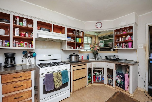 1037 Collingswood Dr, Corpus Christi, TX 78412 - kitchen with white gas range, open shelves, under cabinet range hood, and dark countertops