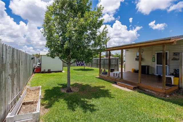 1037 Collingswood Dr, Corpus Christi, TX 78412 - fenced backyard featuring a wooden deck, a storage shed, and a vegetable garden