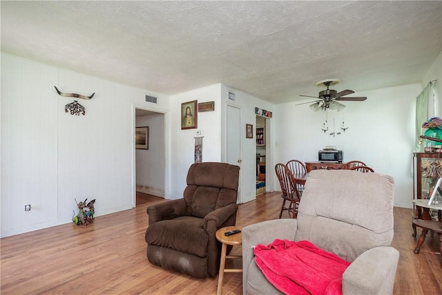 1037 Collingswood Dr, Corpus Christi, TX 78412 - living room with wood finished floors, ceiling fan, and a textured ceiling