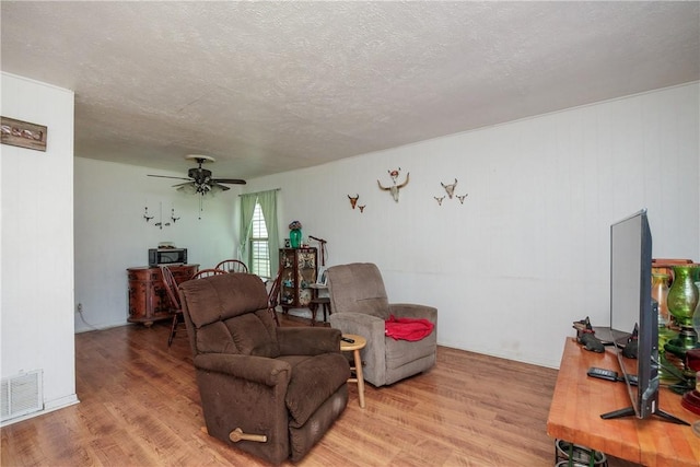 1037 Collingswood Dr, Corpus Christi, TX 78412 - living room featuring light wood finished floors, ceiling fan, and a textured ceiling