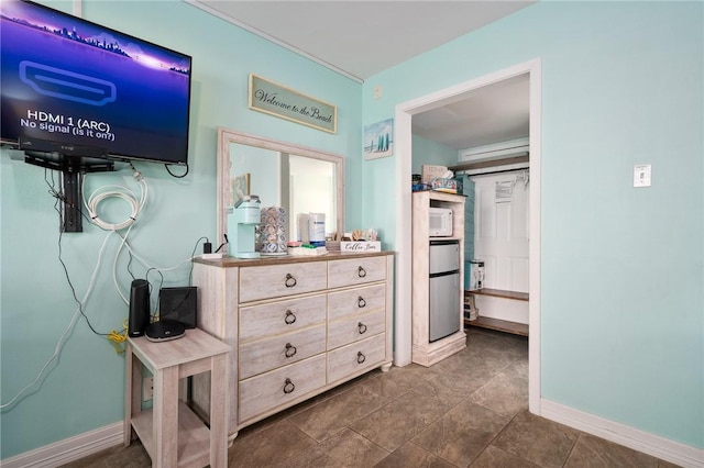 bedroom featuring stainless steel fridge