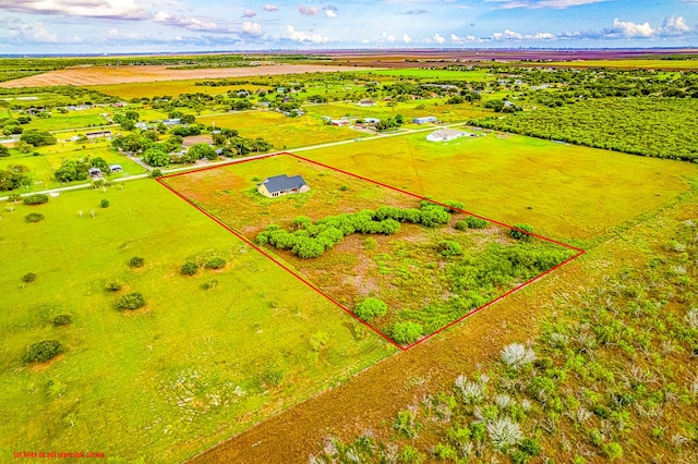 birds eye view of property with a rural view