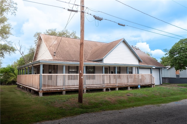 back of property featuring a deck and a yard