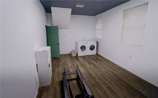 laundry area with wood-type flooring and washer and dryer