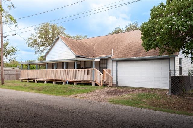 view of front of property featuring a garage and covered porch