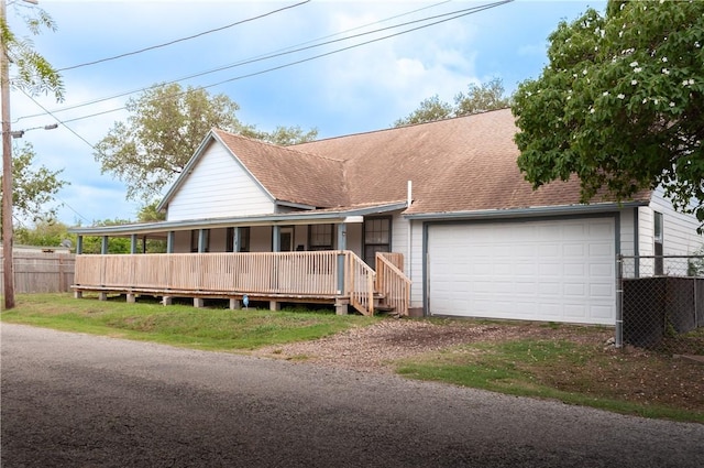 310 N Harrell, Bishop, TX 78343 - view of front facade with covered porch, dirt driveway, roof with shingles, and a garage