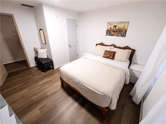 bedroom with hardwood / wood-style flooring and a closet