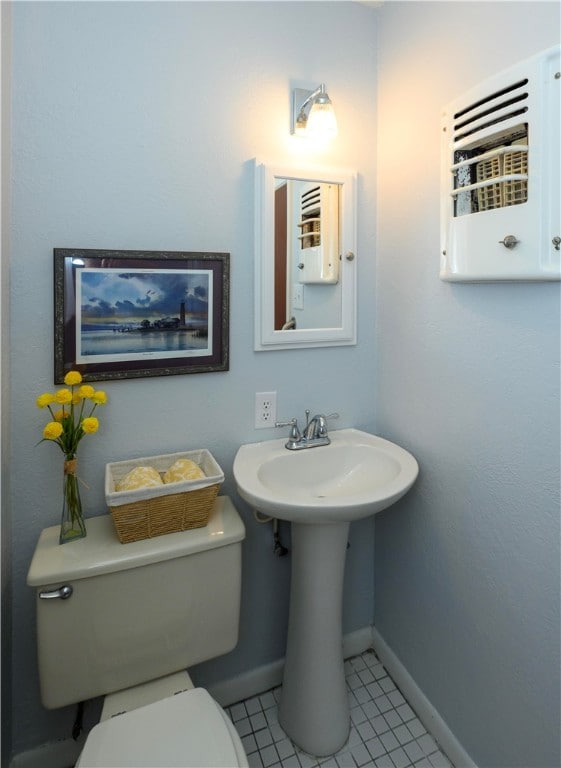 bathroom featuring toilet and tile patterned floors