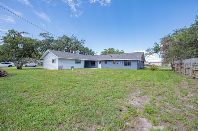 rear view of property with a yard