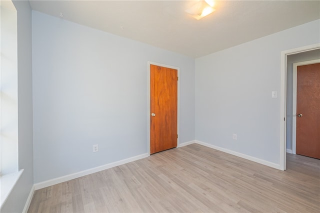 spare room with light hardwood / wood-style flooring