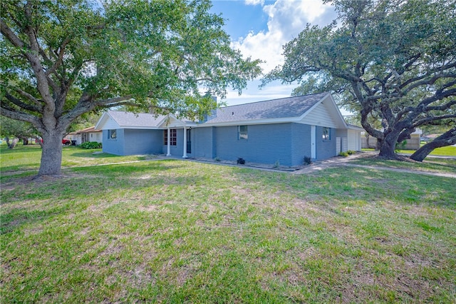 rear view of house featuring a lawn