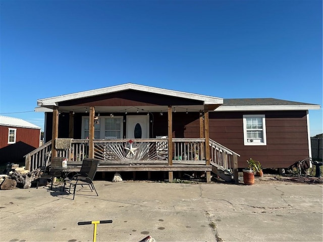 view of front of property with covered porch and a patio