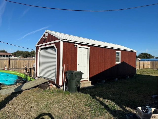 view of outbuilding with a yard