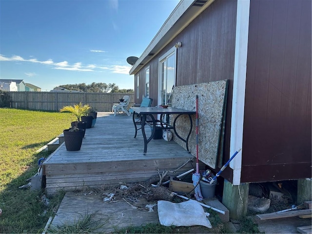 wooden terrace featuring a yard