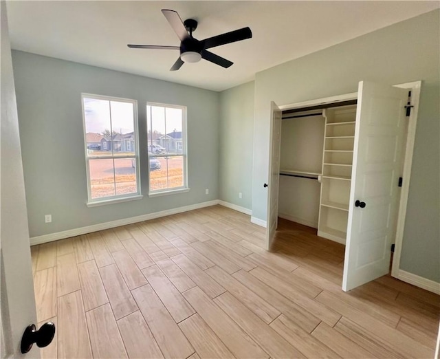 unfurnished bedroom featuring ceiling fan, light wood-type flooring, and a closet