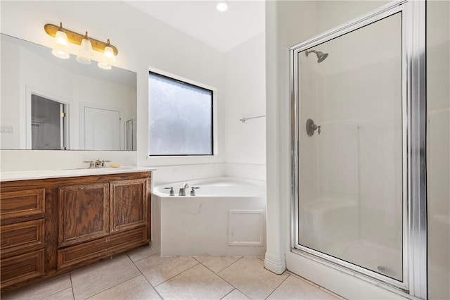 full bathroom with a garden tub, a shower stall, vanity, and tile patterned floors