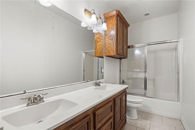 full bath with tile patterned flooring, shower / bath combination with glass door, a sink, and toilet