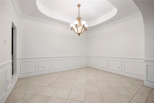 empty room featuring light tile patterned floors, a raised ceiling, and a notable chandelier