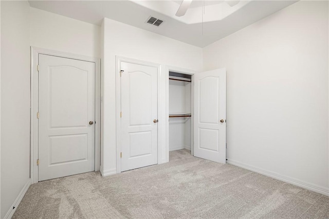 unfurnished bedroom with a closet, carpet flooring, visible vents, and baseboards