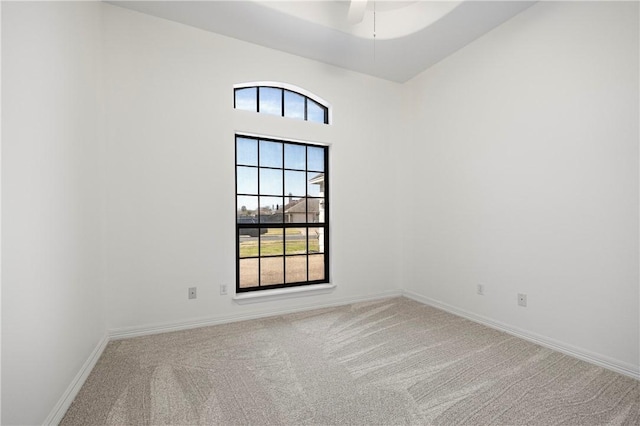 empty room featuring baseboards and carpet flooring