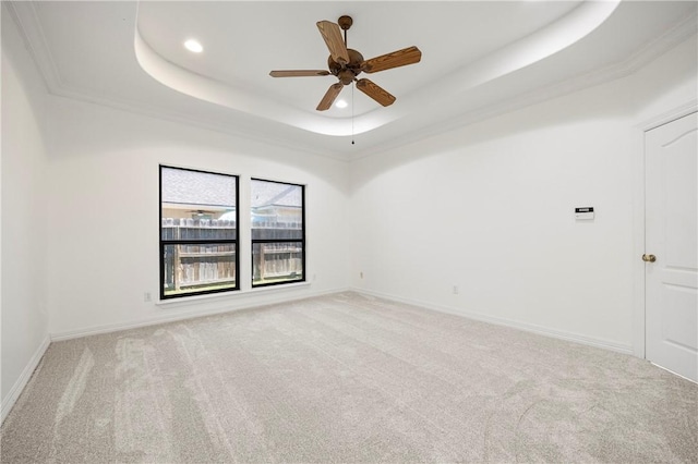 carpeted spare room featuring baseboards, a tray ceiling, ceiling fan, and recessed lighting