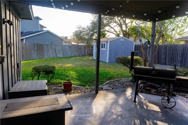 view of patio with an outbuilding, a storage unit, and a fenced backyard