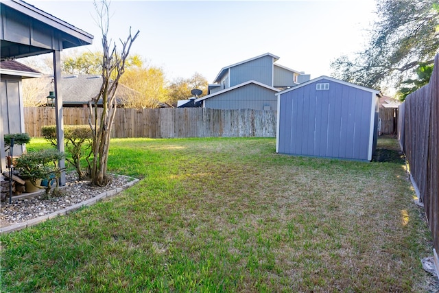 view of yard featuring a shed, an outdoor structure, and a fenced backyard