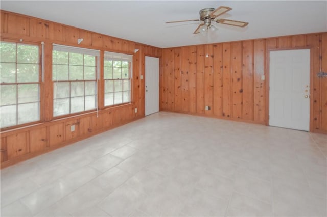 613 Brawner Pkwy, Corpus Christi, TX 78411 - spare room with a ceiling fan and wood walls
